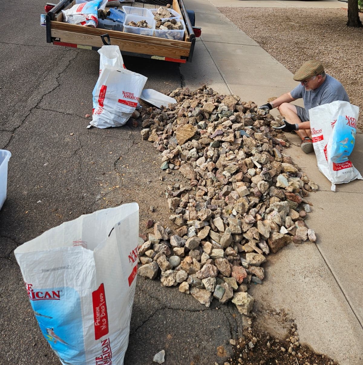 Rough rock being bagged off a curb and loaded for the studio.